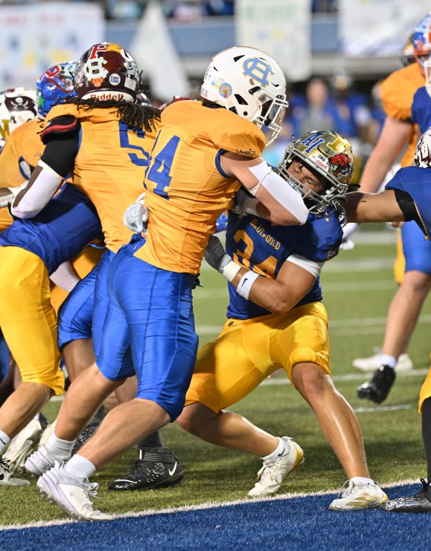 Cape grad and Gold squad tight end Zane Coulbourne makes a crushing block on Blue’s Mitch Cummings (Sallies).
