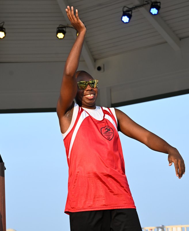 Waving to the crowd is Special Olympics Athlete of the Year Deshawn Scye. He will light the cauldron at the opening of the Summer Games.