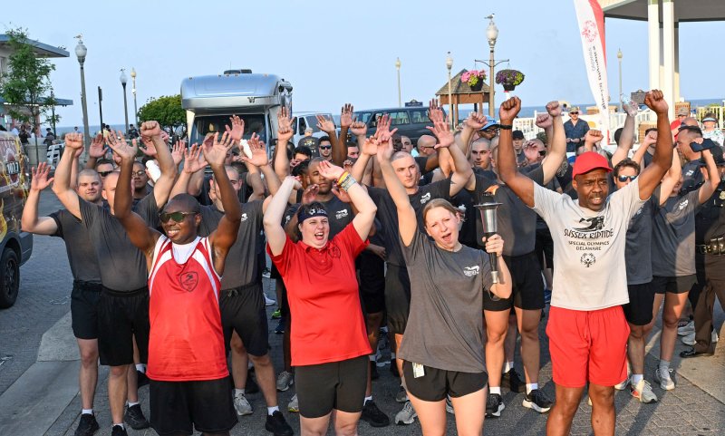 Special Olympics athletes and law enforcement officers from around the state prepare to run from the Bandstand during the 39th annual Law Enforcement Torch Run. Shown leading the group are (l-r) athlete Deshawn Scye, athlete Maura Ganc, Rehoboth police officer Sara Rowley and athlete Tony Bowe. DAN COOK PHOTOS