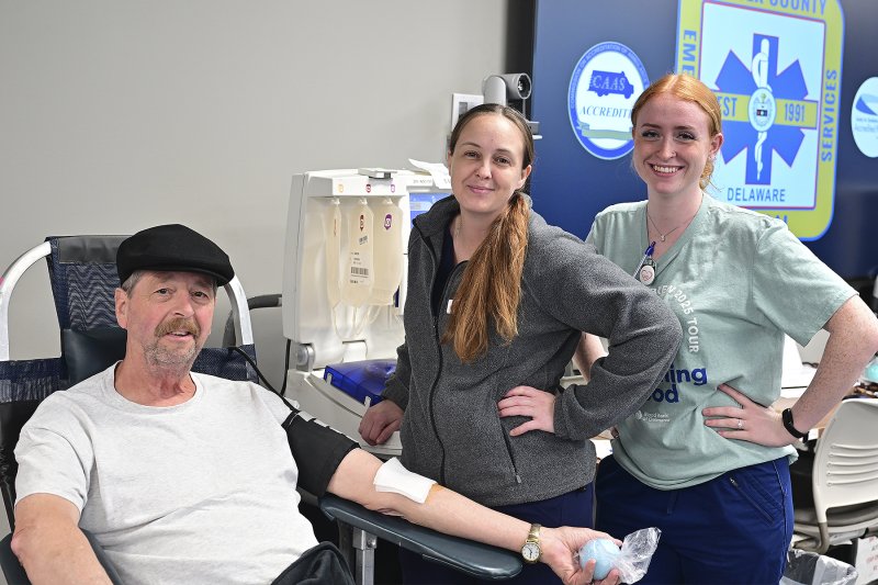 Francis Beall gets a visit from Chelsea Akers and Daisy Tannen, supervisors for the Blood Bank of Delmarva.