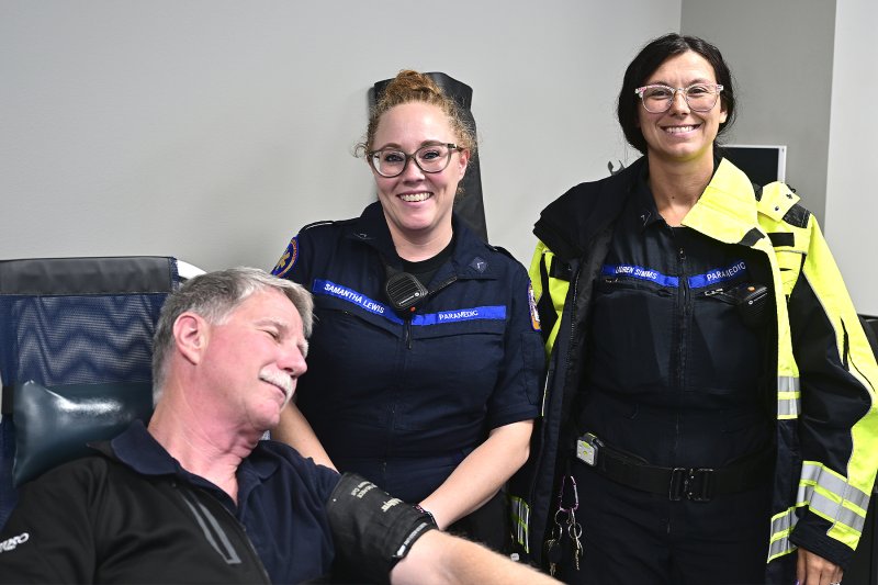 Paramedics Samantha Lewis and Lauren Simms are looking after Glenn Marshall, special operations manager for Sussex County EMS, as he pretends to sleep.