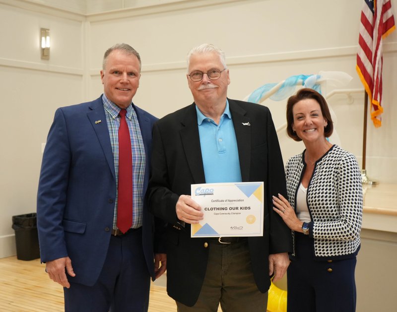 Bob Blouin, middle, president of Clothing Our Kids, accepts a certificate of appreciation from Cape Henlopen School District leaders after they named his organization their May Community Champion at the May 22 school board meeting. Next to Blouin are Superintendent Bob Fulton, left, and board President Alison Myers. ELLEN MCINTYRE PHOTO