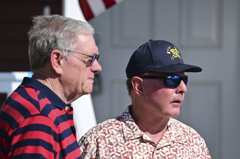 West Rehoboth Land Trust board member Sam Cooper, left, talks with former Sussex County Councilman Mark Schaeffer before the ceremony.