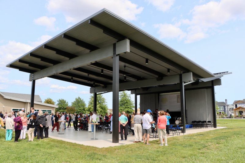 Attendees at the June 1 ribbon cutting mingle under the pavilion. The first of 15 Summer Scape series performances will be held at 7 p.m., Wednesday, June 11.