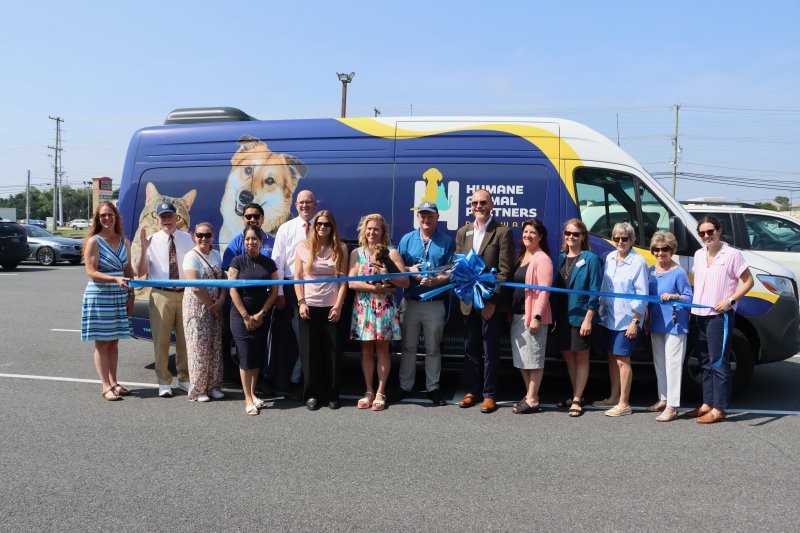 Patrick Carroll, Humane Animal Partners CEO, cuts the ribbon on the animal rescue organization’s new mobile veterinary clinic June 12 at HAP’s Rehoboth Beach location. Shown are (l-r) Meghan Hyett, Rehoboth-Dewey Chamber of Commerce; Stan Mills, Rehoboth Beach mayor; Danielle Colgan, Hook PR; Brentdy Chavez, Children and Families First; Jasmine Delfin-Reyes, Children and Families First; Sen. Russ Huxtable, D-Lewes; Talbot Buck, Rehoboth-Dewey Chamber of Commerce; Leigh McKinley, HAP Sussex County director; Patrick Carroll, HAP CEO; Terry Kistler, WSFS Bank; Michele Gallante, WSFS Bank; Kate Callihan, HAP director of philanthropy; Dorothy Filbert, creator of Sandy’s Fund; Carol Everhart, Rehoboth-Dewey Chamber of Commerce president and CEO; and Emily Moody, Rehoboth-Dewey Chamber of Commerce. BILL SHULL PHOTOS
