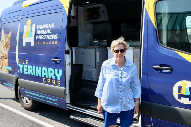 Dot Filbert stands in front of HAP’s new mobile veterinary van. Filbert started Sandy’s Fund, named after her 12-year-old rescue dog, to help pay for free spay and neuter clinics.