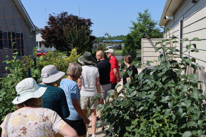Visitors admire part of the garden belonging to Helen Waite and John Feliciani at 10 Henlopen Court.