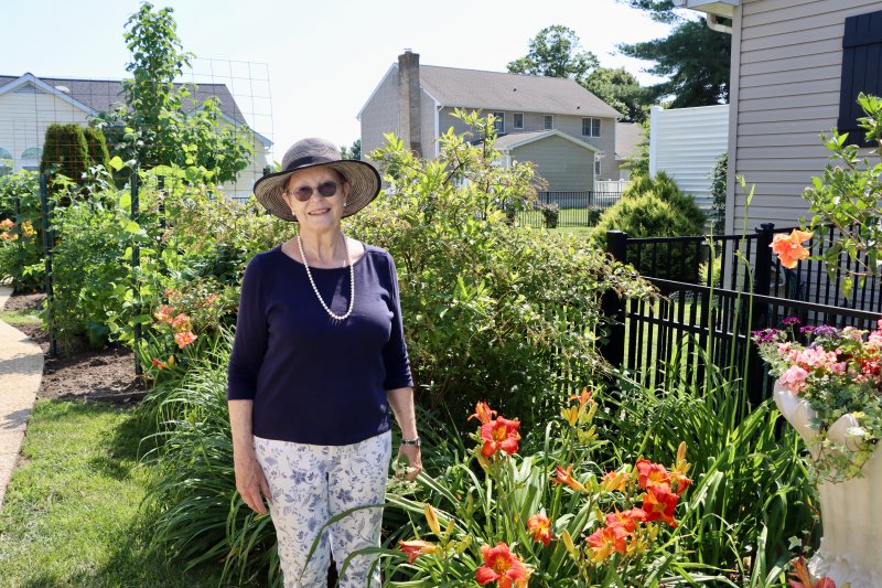 Helen Waite poses in her garden. When she is not working hard on her own backyard, she is the garden manager at St. Peter’s Episcopal Church.