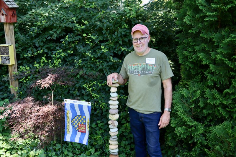 The owner of 9 Drake Knoll, Dave John, standing in one of the quiet corners of his outdoor space. John said his favorite spot is the area by the pond, because of the sound of the water and the shade.