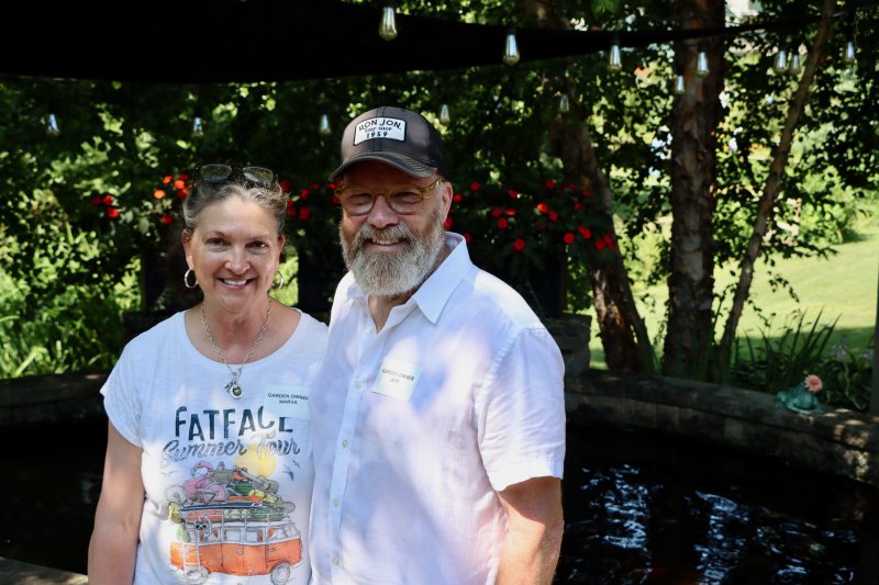 Marva and Jeff Heckert, owners of 15 DeVries Circle, stand in front of one of their favorite features, a fish pond on their patio.