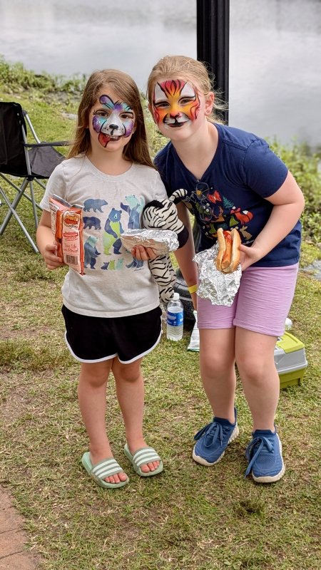 Ellie Reddick, 5, and her sister Iris, 9, are about to enjoy their lunch with a fresh coat of paint on their faces.