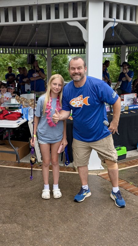 Techno Goober owner Frank Payton poses with 12-year-old Brandi Pange, the overall girls’ winner in tournament history.