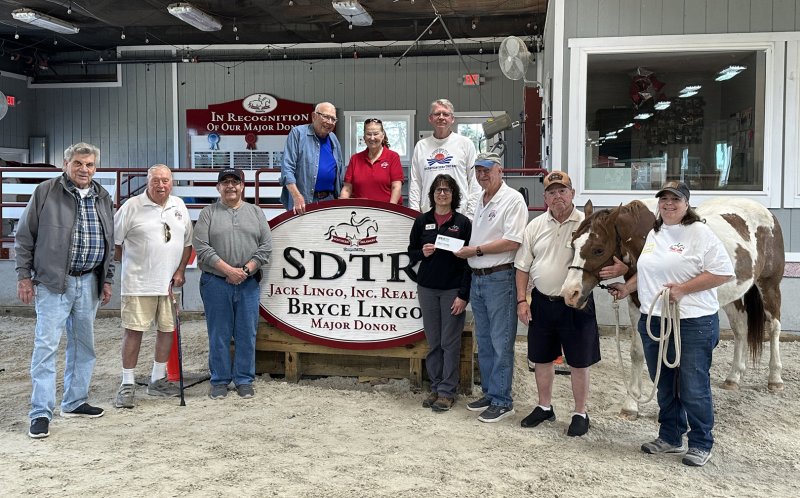 Check presentation attendees shown are (l-r) Gary Azukas; Jim Quigley; Michael Vari; Michael Fishman; Nancy Bush; Brian Moyer; Kelly Boyer, SDTR program director; Robert Trafton, chair, Elks veterans committee; John Dill, SDTR program participant; Patches the horse; and Lucia Lombardi, SDTR veteran program coordinator. Not pictured is Jo Allegro-Smith, SDTR executive director. SUBMITTED PHOTO