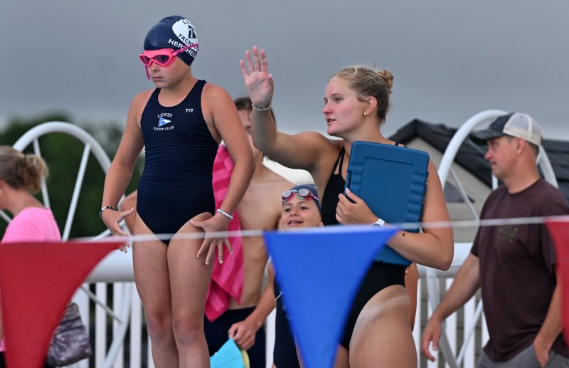 LYC coach Jenna Reinhold gives instruction to Cora Hershelman, 10, before the 9-10 girls’ 25-meter butterfly.