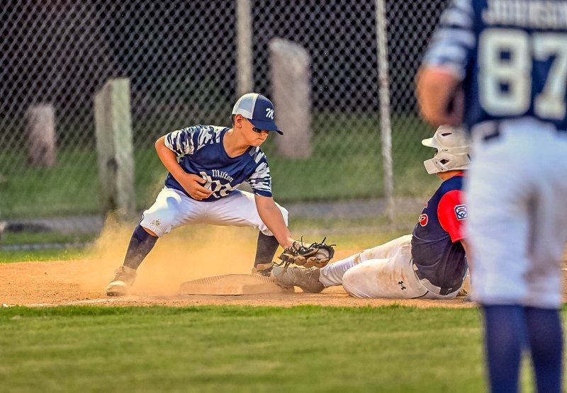 Milton third baseman Jase DeLacy. puts the tag on a baserunner, but it was just a bit too late for an out.