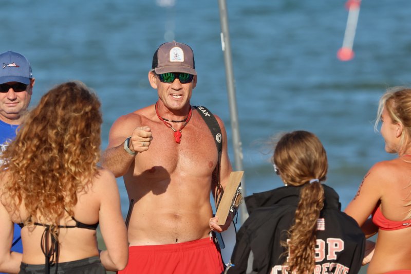 Derek Shockro, Rehoboth Beach Patrol chief, gives instructions to the lifeguards who were competing in the evening’s events.