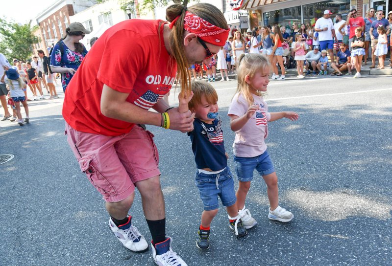 Jackson Reifsnyder, center, and his sister Harper get a little help from their dad Josh during the three-legged race.