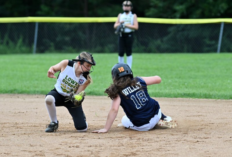 Milton pitcher Pyper Willey slides safely into second beating the tag of Lower Sussex’s Julia Owens.