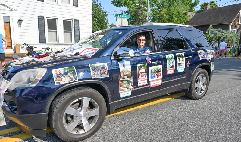 Kathy Moon drives a car that displays photos that pay homage to the founders and longtime participants and supporters of the Doo-Dah Parade.