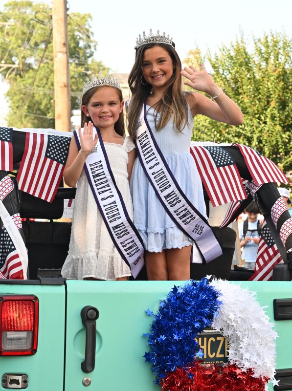Delmarva Young Miss Lewes Alanno Mayo, left, and Delmarva Junior Miss Lewes Erin Mayo wave to their fans along the route.