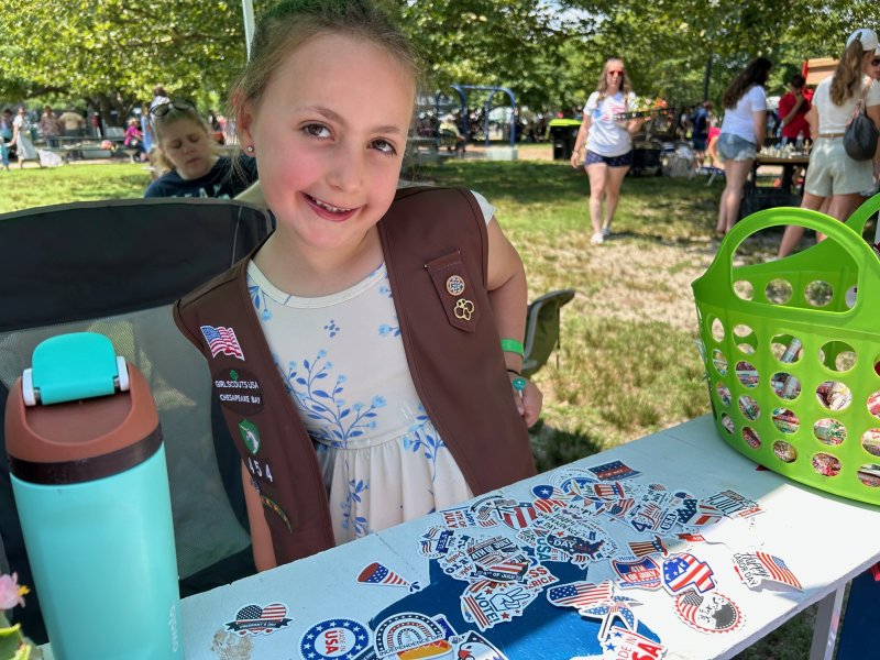 Gabby Oppen, 7, represents Girl Scout Troop 454 at the rubber duck-matching game, where players try to match the numbers on the ducks for a prize.