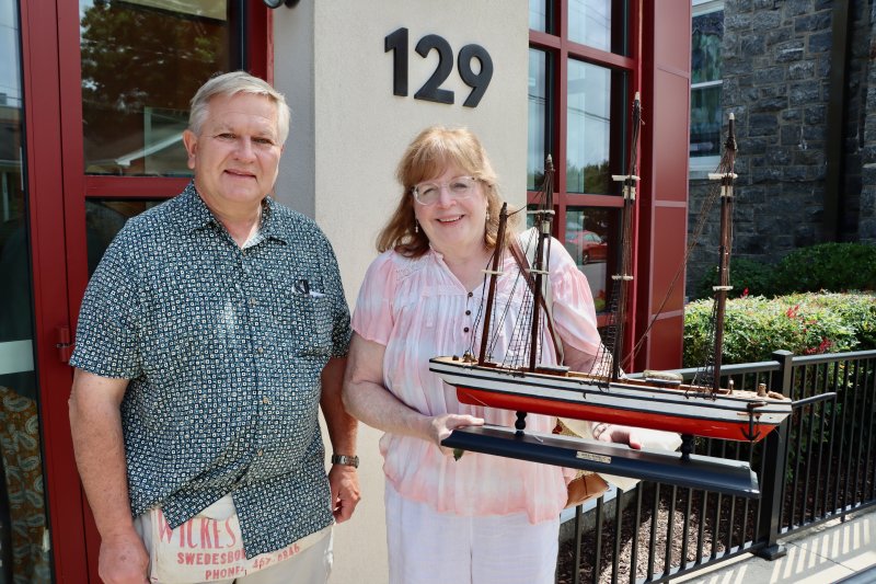Chris Alabrudzinski of Primehook Pickers, left, with Michelle Arrington of Bridgeville. She bought the model of the Great Republic clipper ship from Alabrudzinski as a decoration for her home.