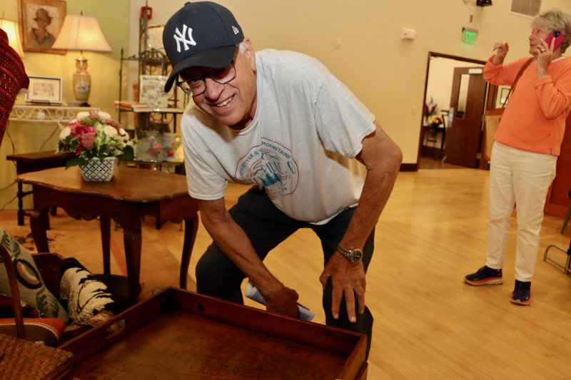 Saul Wendroff of New York looks at a table with an old map of New York City at Barbara Rew Antiques.