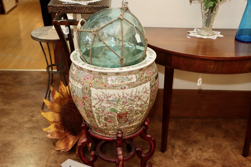 A large, glass net float in a very large vase was for sale by a vendor in the lobby of the parish hall.