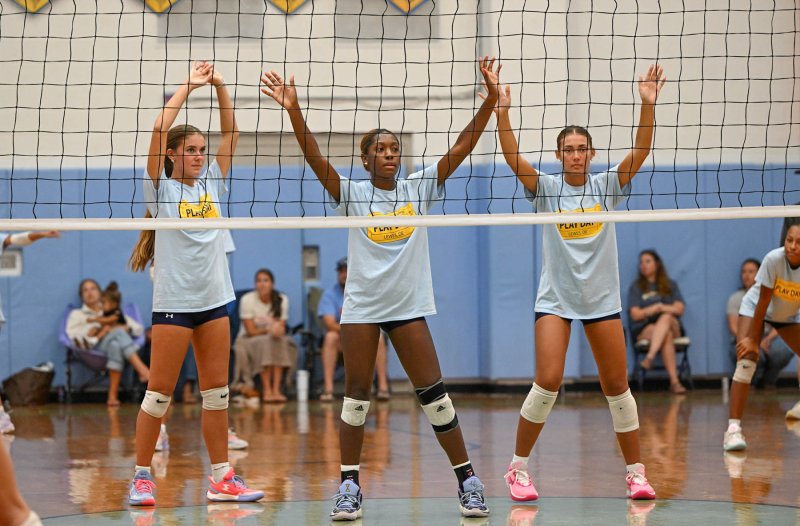 Awaiting a serve are (l-r) Camilla Willis, McKenzie Everson and Maile Godwin.