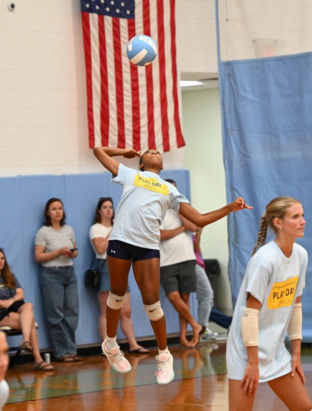 Journey McDaniel pounds a serve in the scrimmage with Caravel.