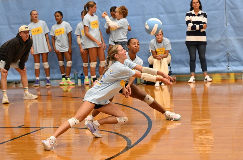 Cape junior libero Amara Fruchtman makes a diving return with teammate Journey McDaniel awaiting to assist.