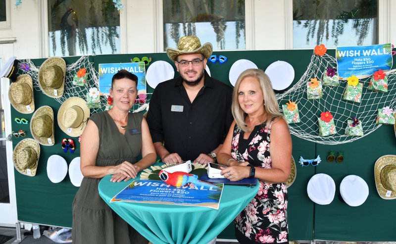 Working the Wish Wall are CBH staff members (l-r) Kenna Chanoux, Enrique Quijada and Barbi Tulowitzki-Hojnicki.