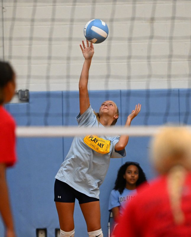 Junior Lindsey Smith slams a serve in the scrimmage with Conrad.