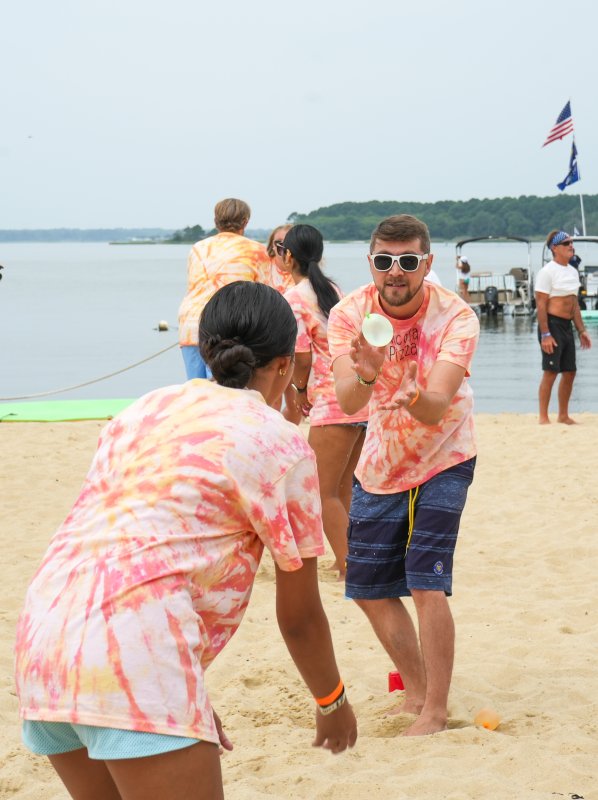 Nicola Pizza’s Sonny Cunningham focuses on catching a water balloon thrown by teammate Katherine Portillo during the water balloon toss.