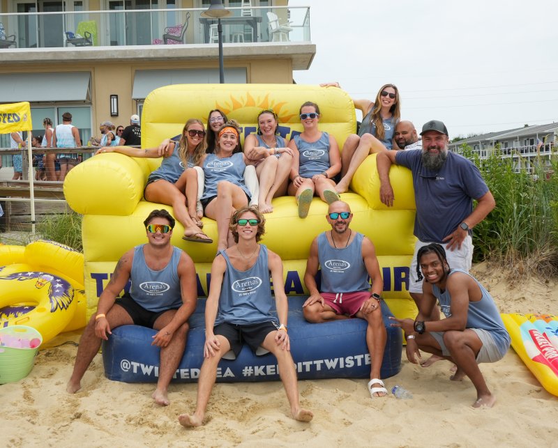 The Arena’s team and supporters sit on and around the Par-Tea Chair. In back are (l-r) Andie Pongracz, Andreea Szilveszter, Joey McHale, Sierra Riedel, Shannon Pyle, Crystal Thomsen, Anthony Baray and Ramsey Schrader. In front are Nick Lambros, Owen Smith, Vitaliy Deyak and Manny Tull.