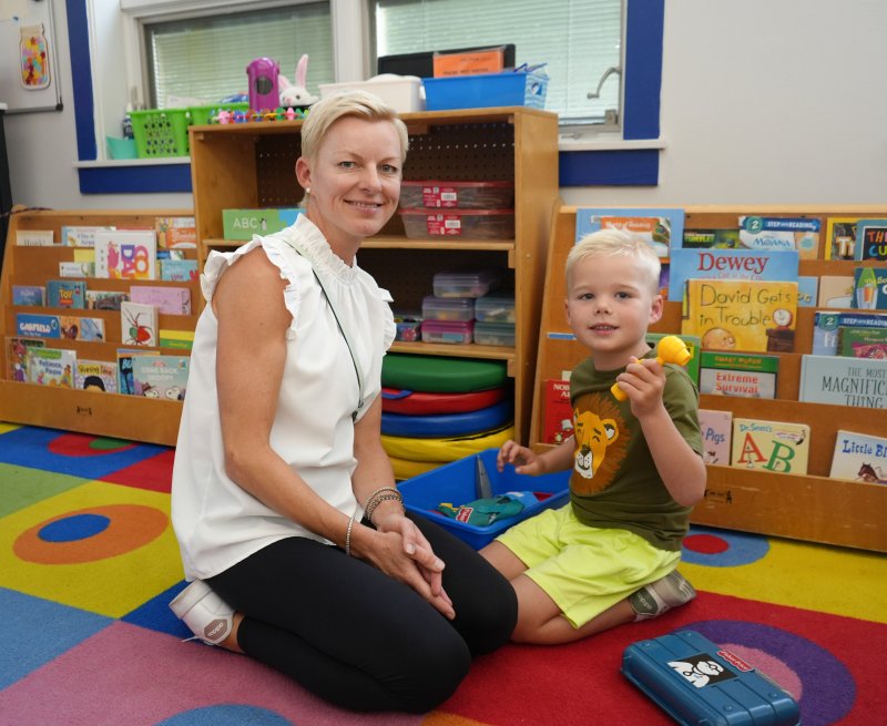 Malgosia Booth and her son Harper, who’s going into kindergarten at Sussex Academy Elementary, sit on the carpet in one of the kindergarten classrooms.