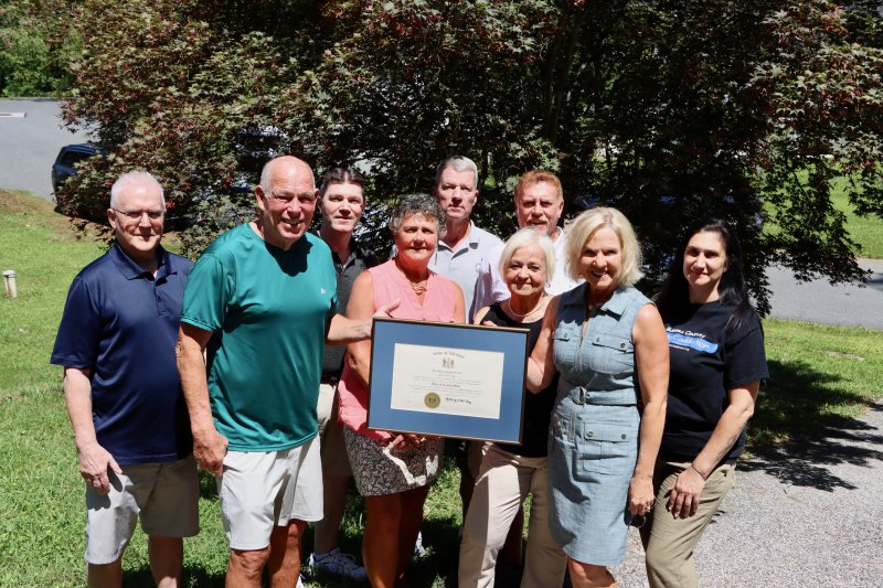 On the day before he died, former Speaker of the House Pete Schwartzkopf and former Lt. Gov. Bethany Hall-Long visited John Brady at his home to present him with the Order of the First State, Delaware’s highest civilian honor. Shown in back are (l-r) Bill Brady, brother; J.P. Miller, brother-in-law; and Jim Brady, brother. In front are Kevin Brady, cousin; Schwatzkopf; Nancy Miller, sister; Pat Campbell-White, friend and caregiver; Bethany Hall-Long, former lieutenant governor; and Amy Rust, caregiver. BILL SHULL PHOTO