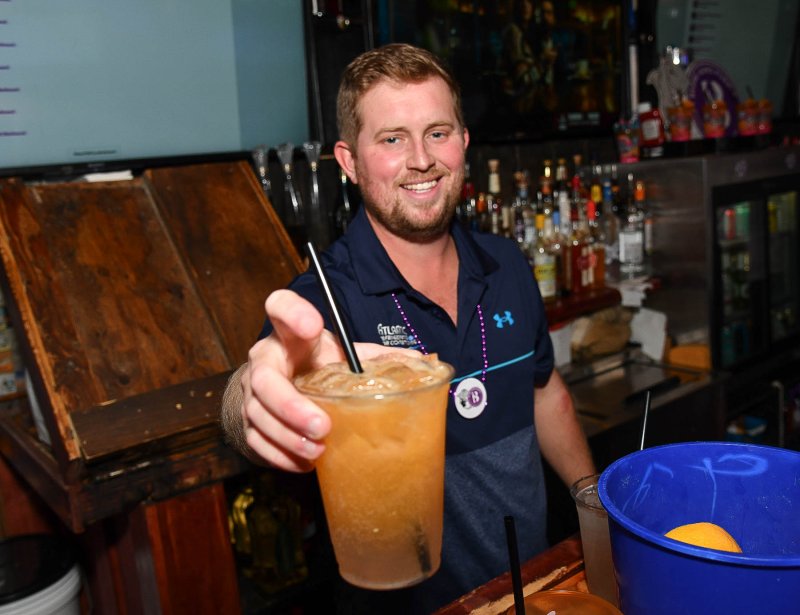Guest bartender and Atlantic Refrigeration co-owner Connor Jones makes a tasty orange crush. He took top honors for donations raised at the event.
