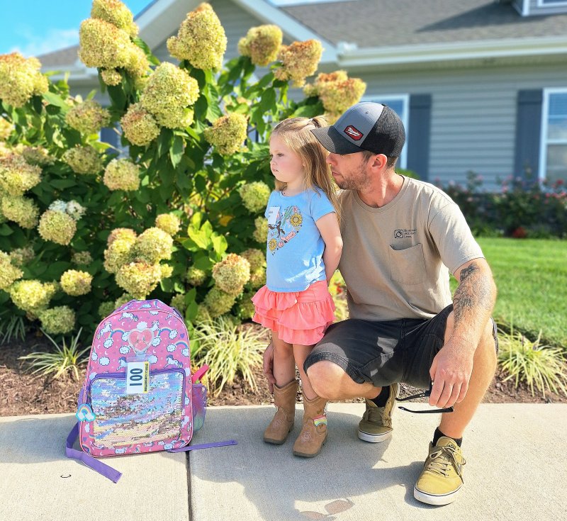 Madeline Klein anxiously waits for the bus to arrive with her dad, Patrick Klein, on her first day of pre-kindergarten at Little Vikings.