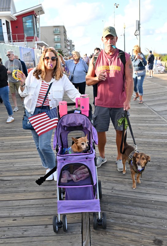 Piping out with their pups are (in stroller) Oriana and owner Mel Kelly and (walking dog) Louie with owner Steve Koester.