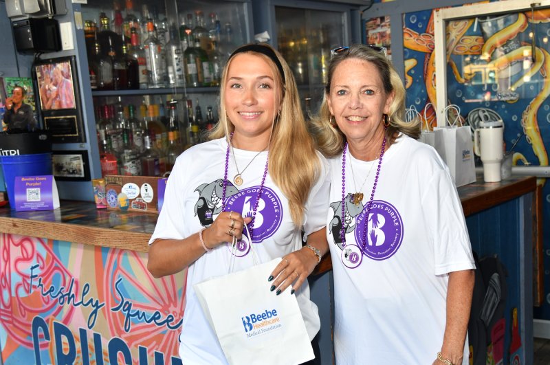 Handing out guest bartender bags with goodies are Olivia Duffield, left, and her mom Karen.