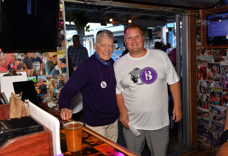 Bill Lee gives a donation to Justen Albright, financial analyst and organizer.