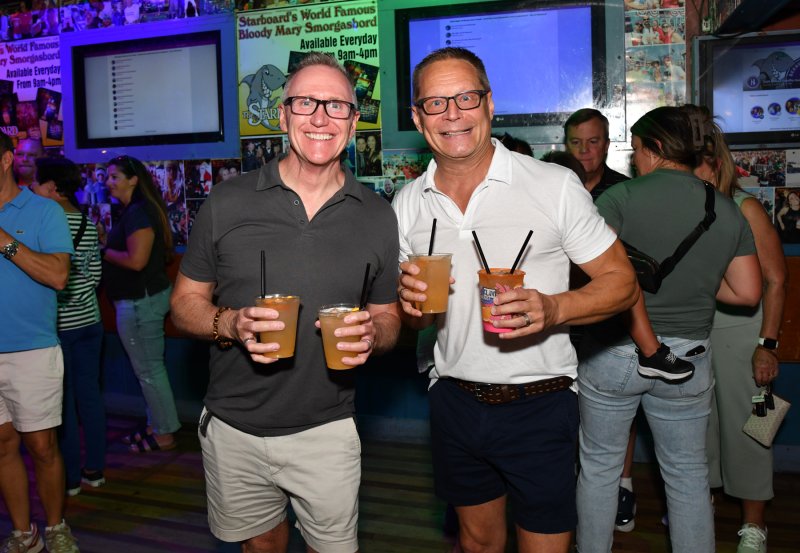 Eric Engelhart, left, and Chris Beagle support the guest bartenders.