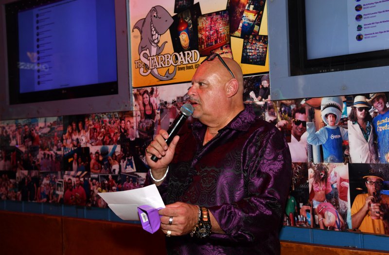 Popular Dewey Beach DJ and emcee for the night DJ Manny Mann gives out times for a bartender change.