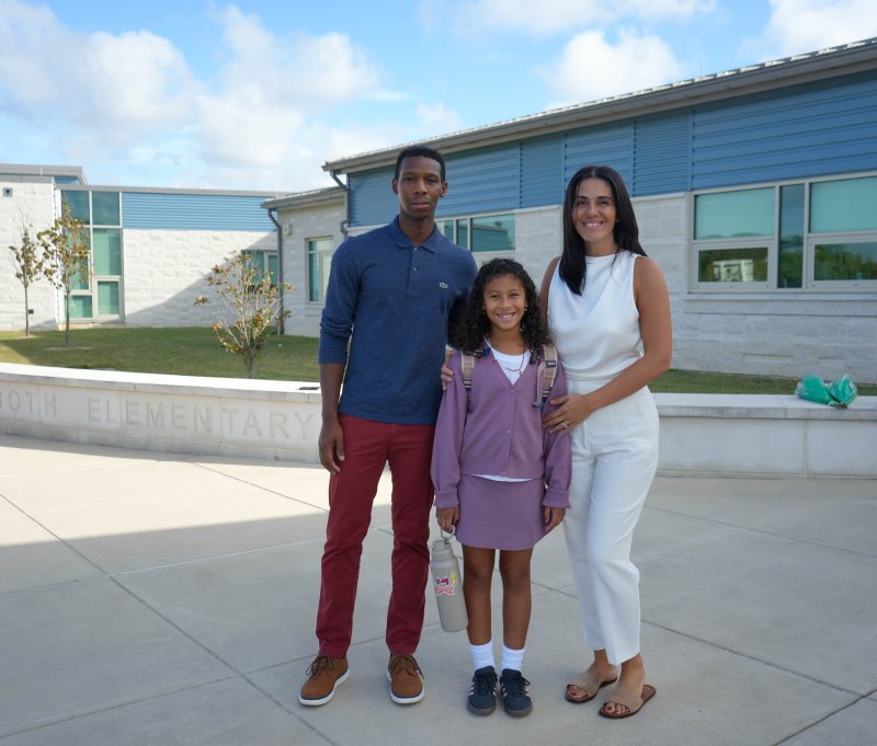 The Riddick family says their goodbyes ahead of the first day. Shown are (l-r) Thomas, third-grader Iman and Adelina. ELLEN MCINTYRE PHOTO