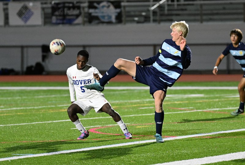 Cape senior Brenner Short boots the ball away from Dover’s Wadley Jecrois.