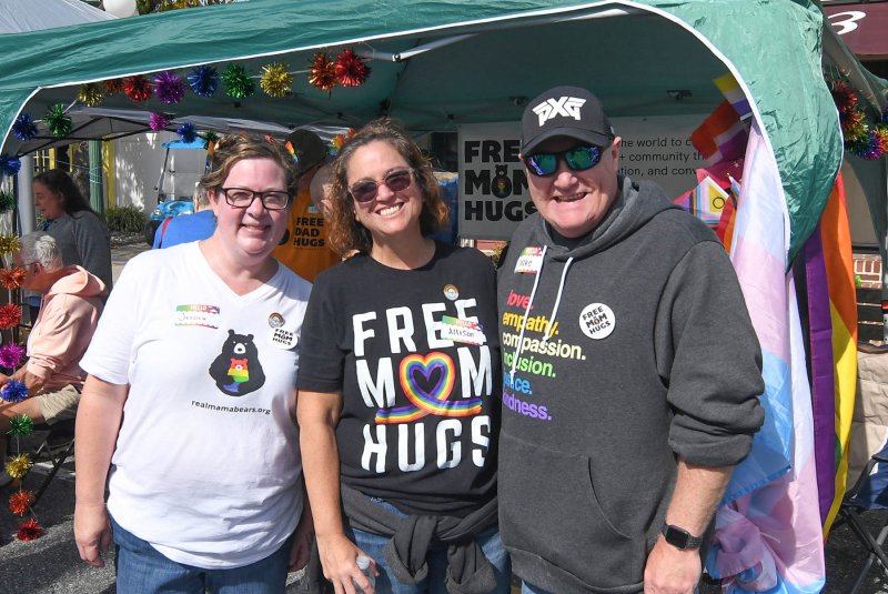 Giving free hugs are (l-r) Jessica Critchlow, Allison Convey and Mike Cook.