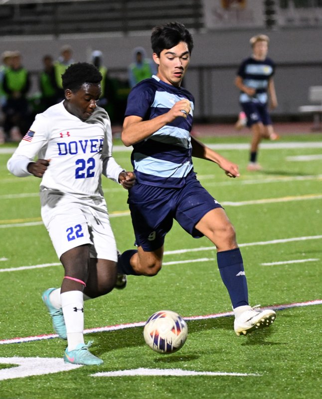 Cape senior Will Burke, right, battles for a 50/50 ball with Dover’s Diego	Ballestas.