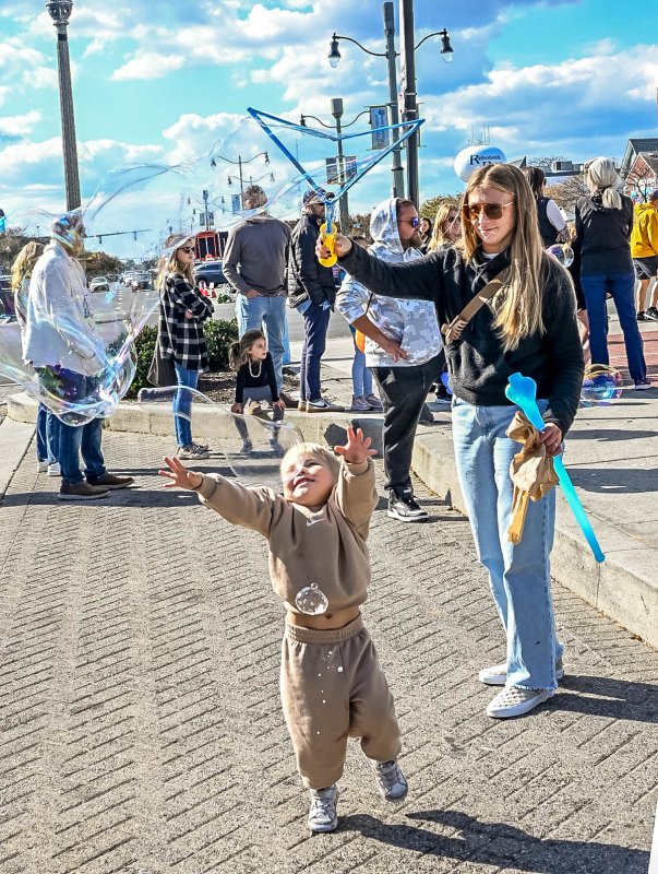 Riley Sukanick, 3, tries to capture a bubble from his mom, Katie. DAN COOK PHOTO