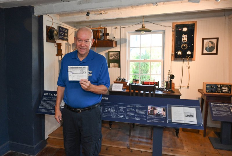 Historic Lewes volunteer Alan Jensen displays a communication from the Titanic at the wireless station in the Cannonball House museum.